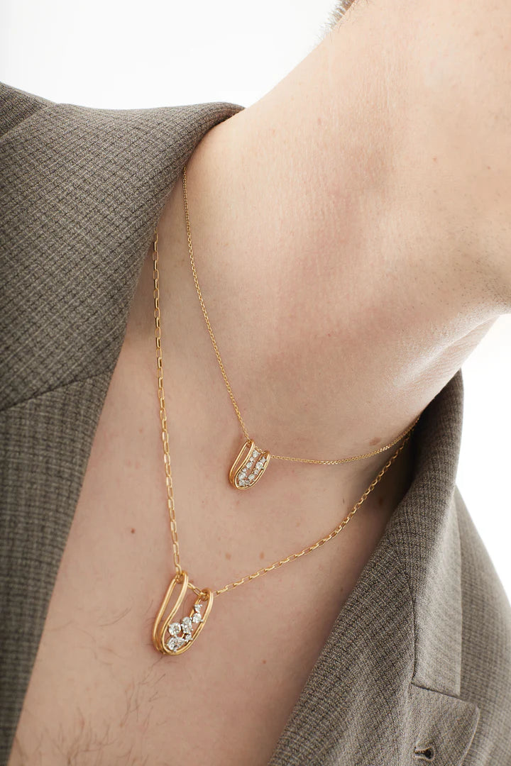 Close up of Full image of Rosario Navia Mara Small Folded Link Pendant in yellow gold on mens neck