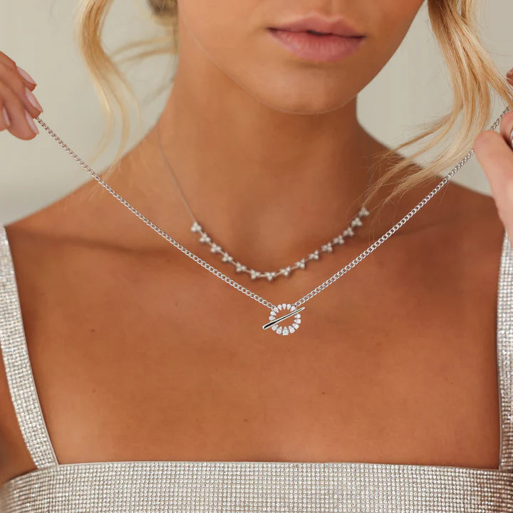 Close up of Dana Rebecca Designs Sophia Ryan Cuban Chain Toggle Necklace in white gold on models hand