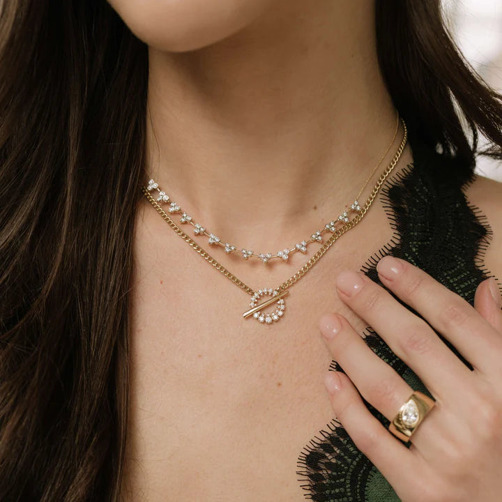 Dana Rebecca Designs Sophia Ryan Cuban Chain Toggle Necklace in yellow gold stacked on models neck with triple diamond necklace