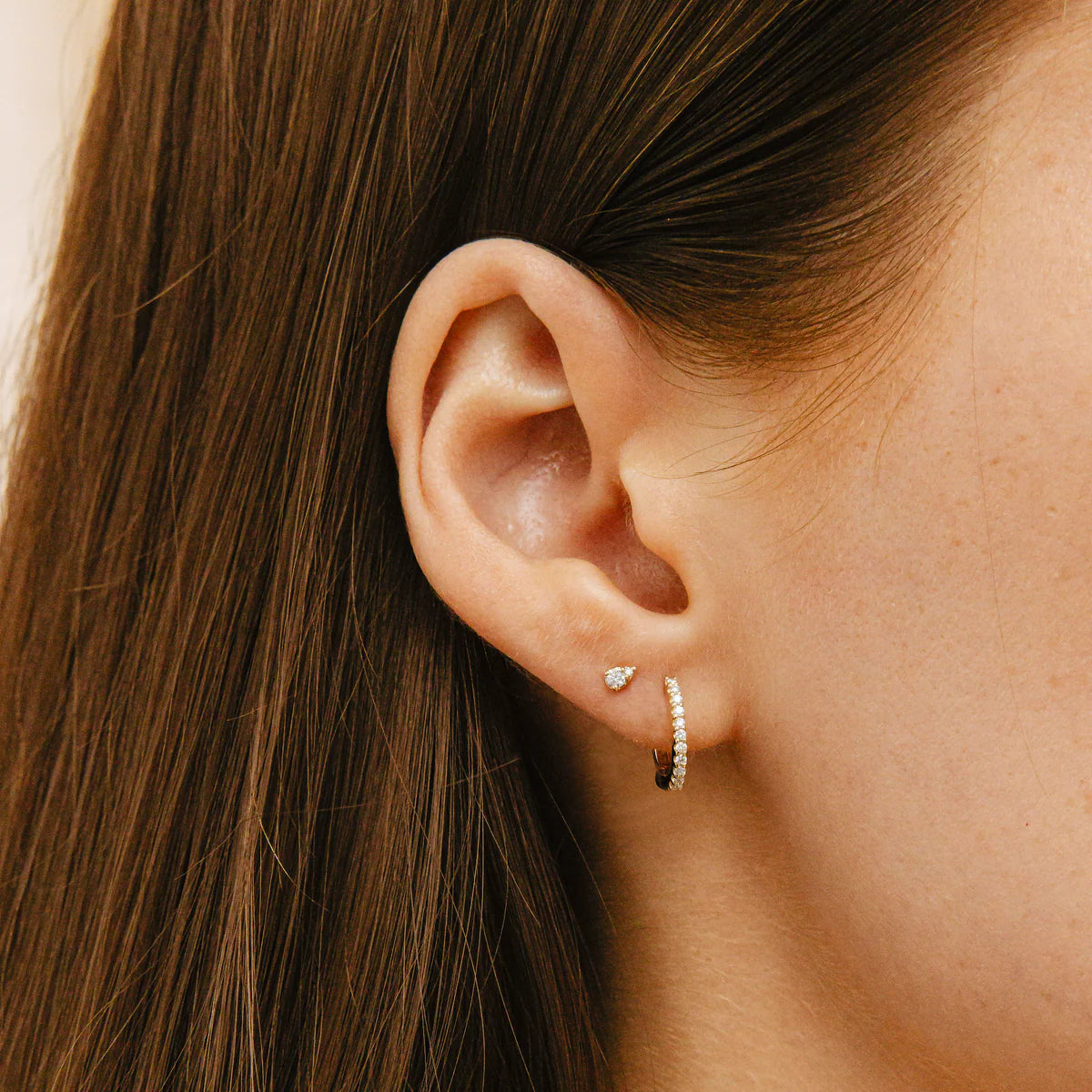 close up of Dana Rebecca Designs Sophia Ryan Petite Teardrop studs in white gold stacked with diamond huggies