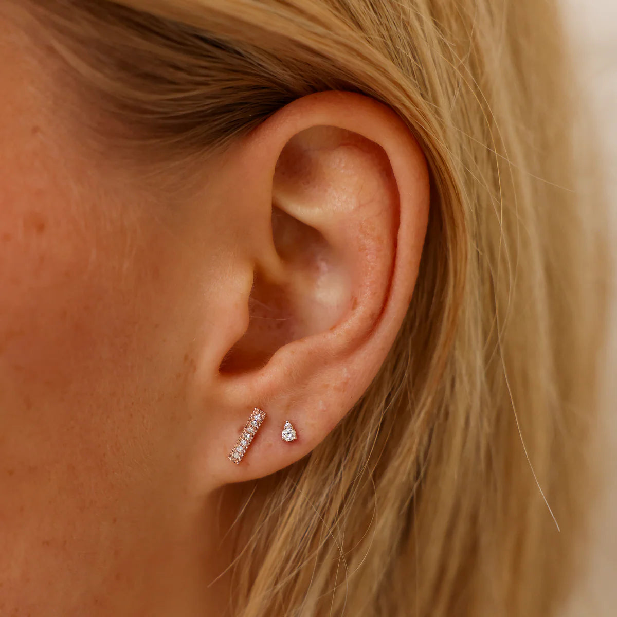 close up of Dana Rebecca Designs Sophia Ryan Petite Teardrop studs in rose gold on model