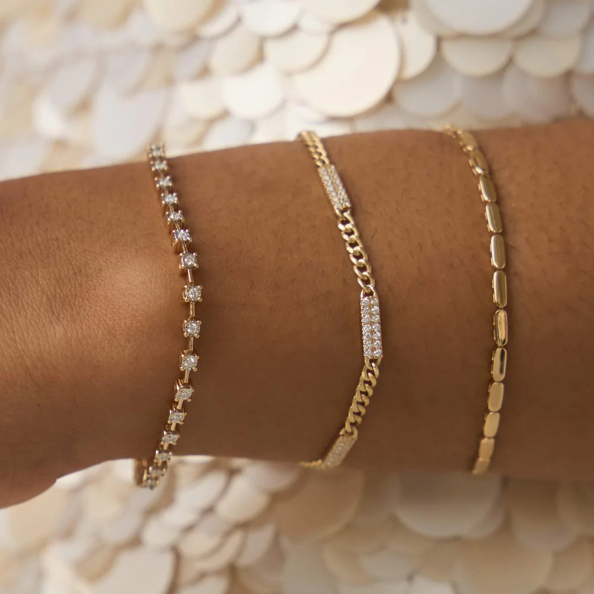 Close up of Dana Rebecca Design Sylvie Rose Cuban Chain Bar Bracelet in yellow gold on models wrist
