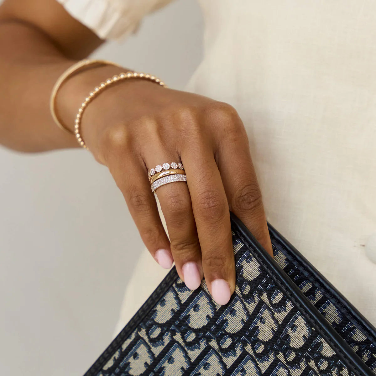 Dana Rebecca Designs Sylvie Rose Large Pavé Ring on models hand in yellow gold styled with a solid gold ring and a diamond ring