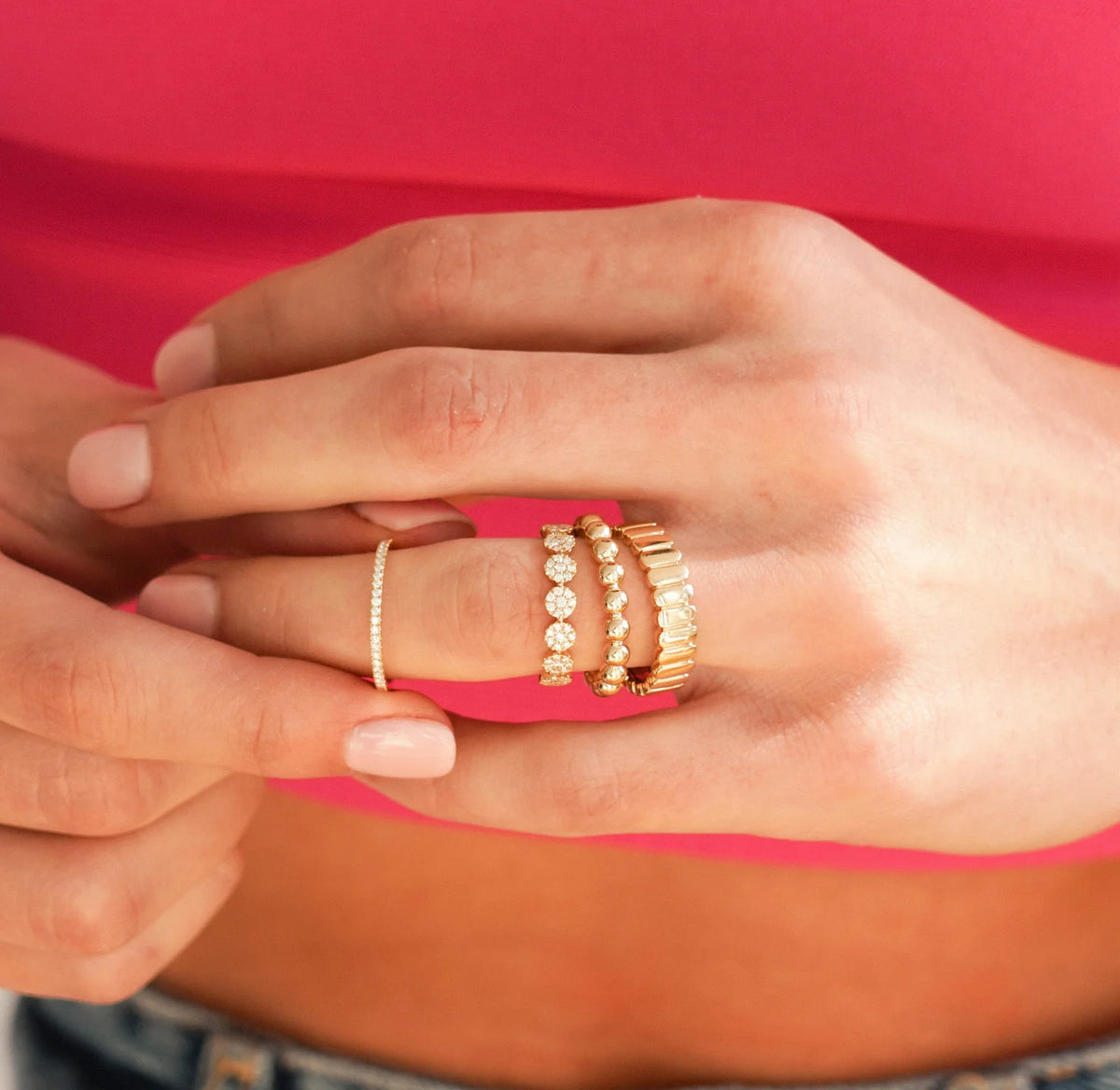 Dana Rebecca Designs Taylor Beth Eternity Band Ring in yellow gold models finger stacked with pebble ring and vertical gold band ring