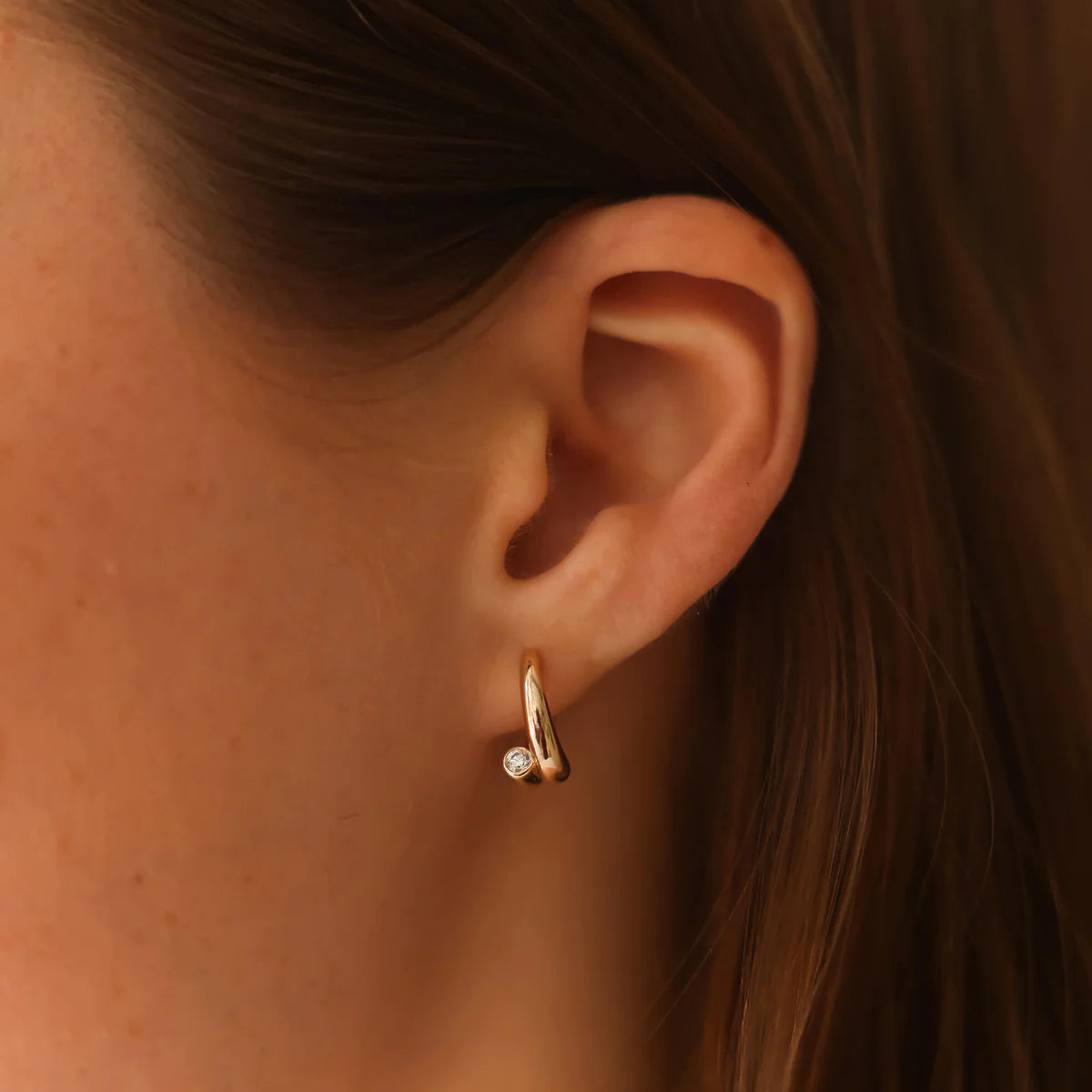 Dana Rebecca Designs Taylor Elaine Bypass Hoop styled in yellow gold on model with brunette hair