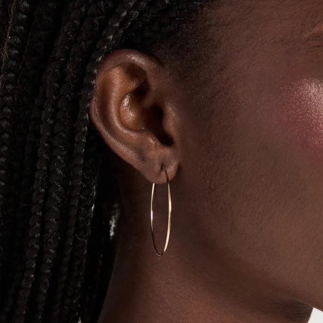 Single EF Collection The Perfect Gold Hoop Earrings in yellow gold styled on models ear.
