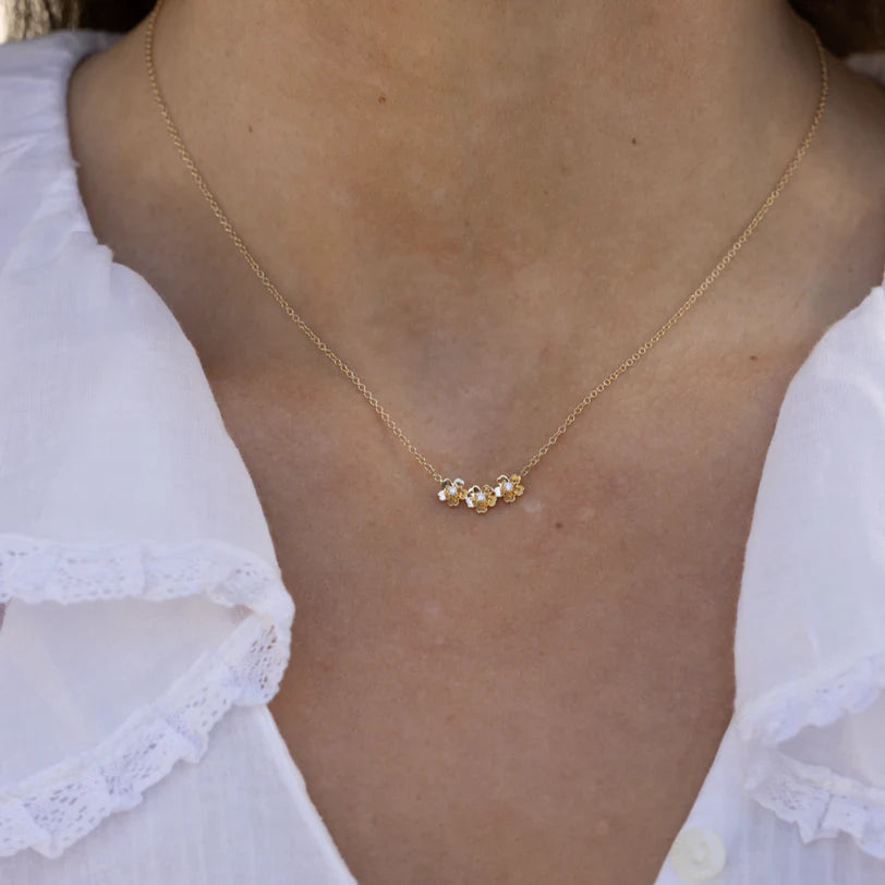 Single EF Collection Triple Gold and Diamond Mini Cherry Blossom Necklace in yellow gold on models neck