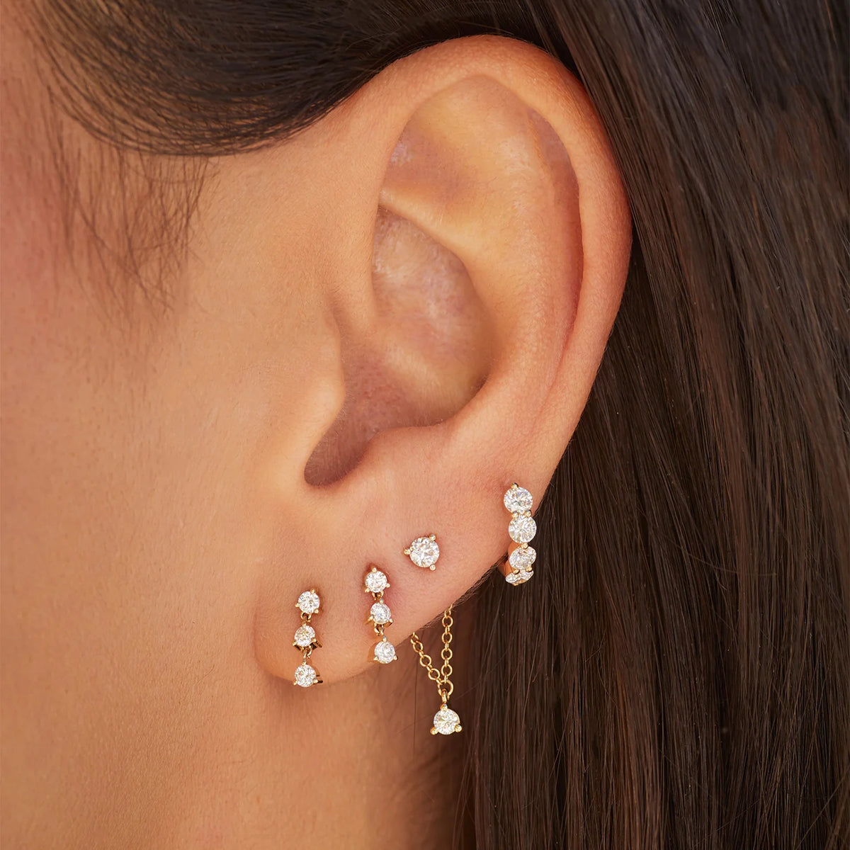 EF-Collection Triple Prong Set Diamond Stud Earrings in yellow gold styled on models ear