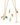 Two Onirikka Gold necklaces with colorful Onirikka enamel charms on a white background