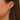 closeup of dana rebecca designs diamond mini huggie staked in an ear