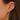 close up of Dana Rebecca Designs mini crescent moon stud earrings in yellow gold on an ear