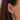 close up of Ava Bea Mini Graduating Hoop in yellow Gold styled on ear with other huggie
