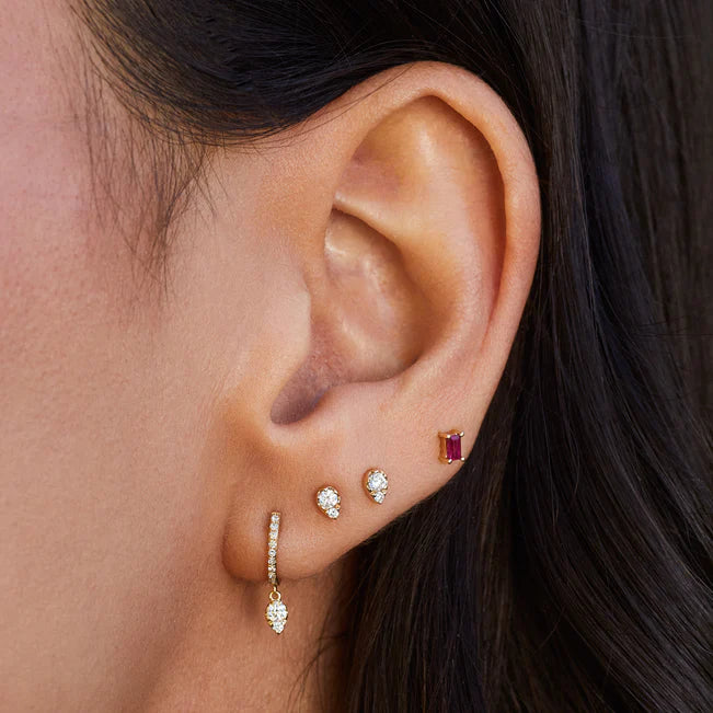 EF Collection Teardrop Diamond Mini Huggie Earring in yellow gold styled on models ear. 