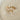 Set of EF Collection gold earrings with pearl accents on a beige surface