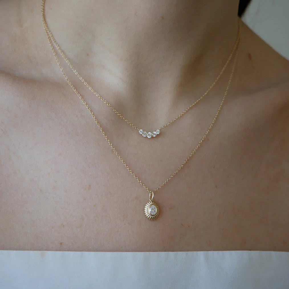 close-up of EF-Collection Graduated Diamond Arc Necklace in yellow gold and diamond on a model's neck. 