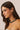 Woman wearing a green beaded necklace against a beige background