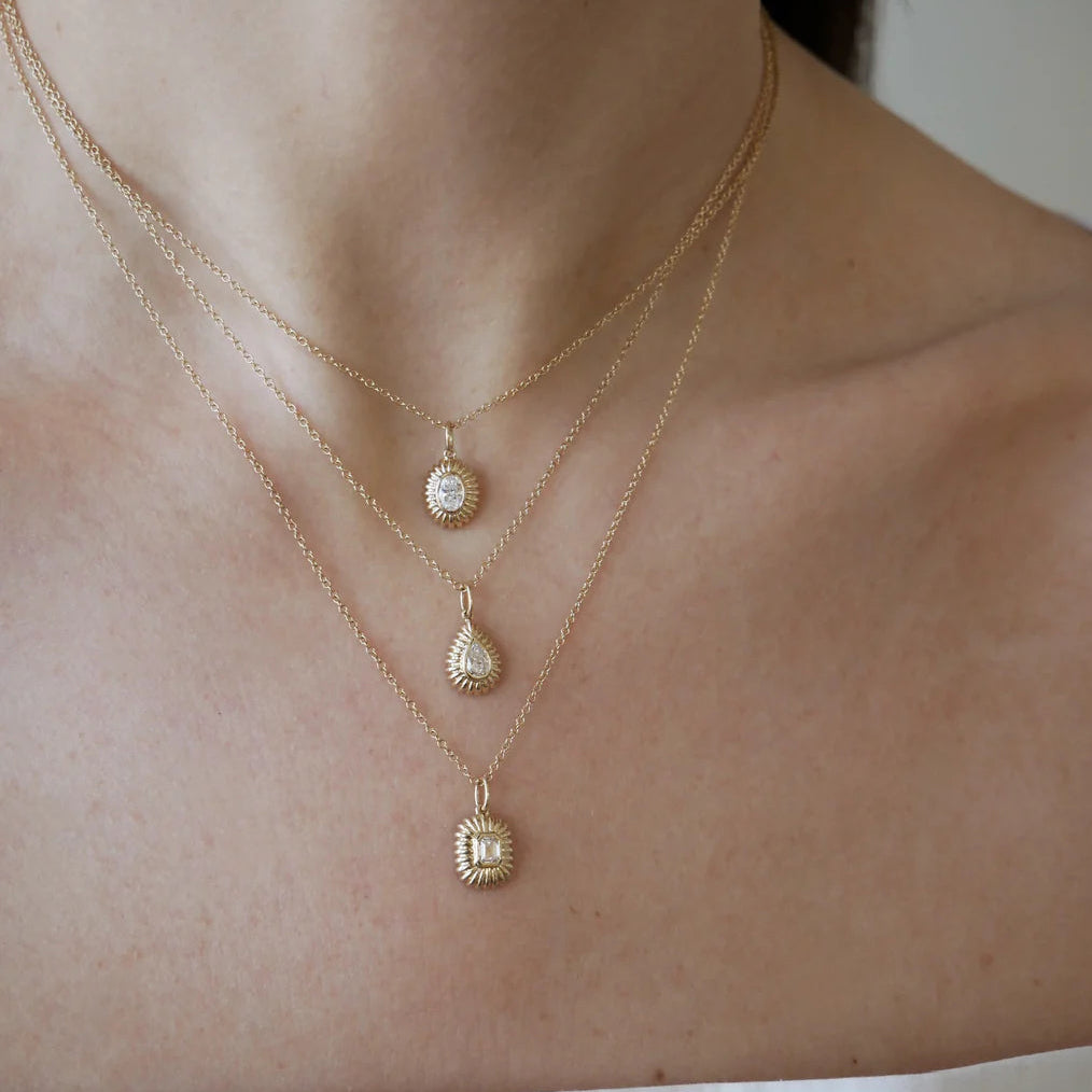 close-up of EF-Collection Fluted Emerald Cut Diamond Necklace in yellow gold and diamond on a model's neck. 