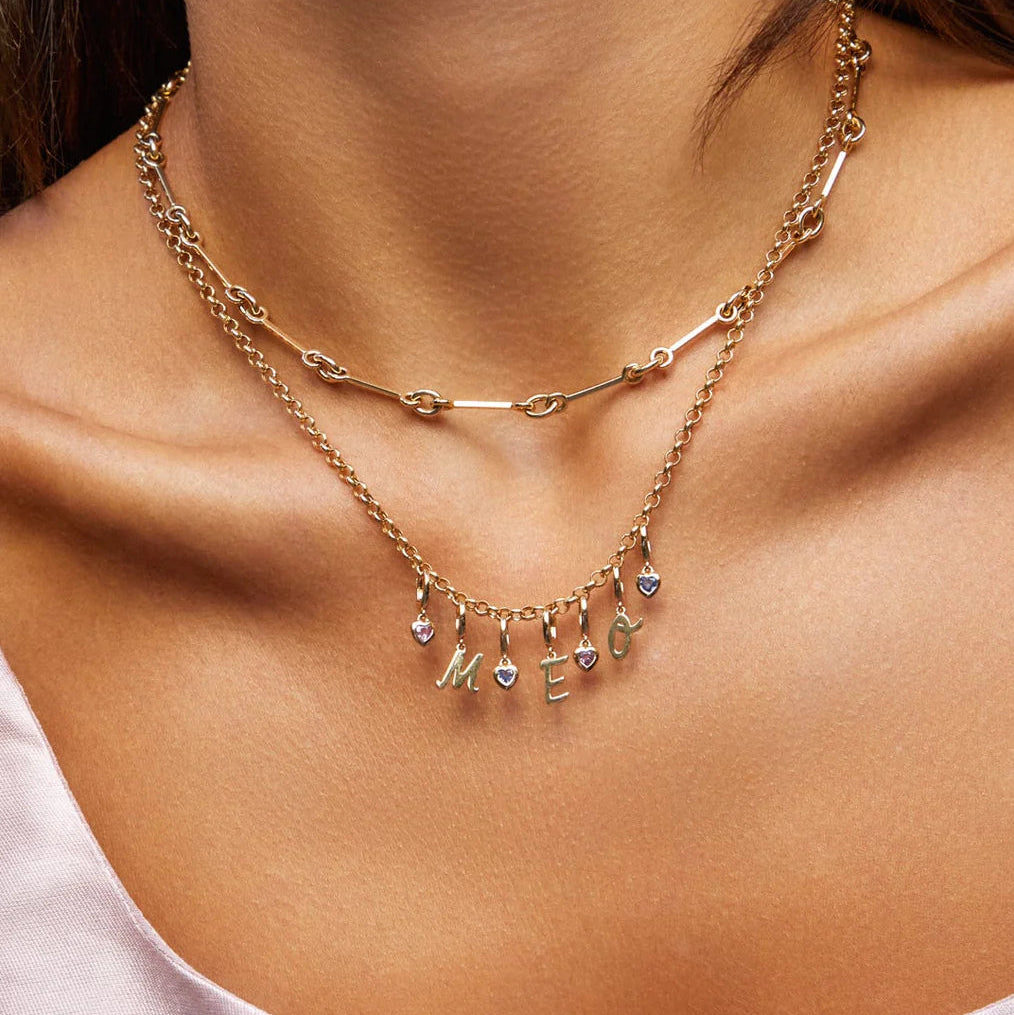 image of EF-Collection Gold Mini Script Initial Clip Charm in rose gold in a chain on a model's neck. 