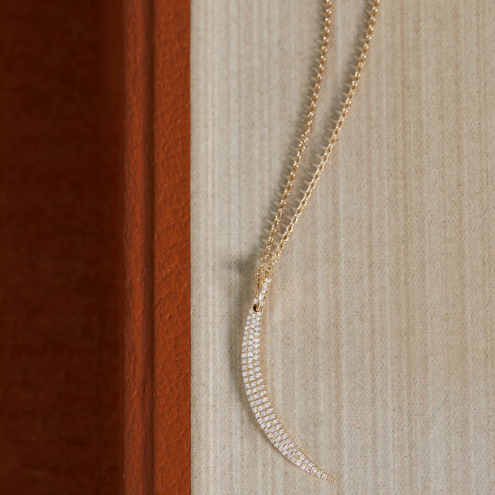 product image of EF-Collection Diamond Crescent Charm in yellow gold and diamond on a textured background. 