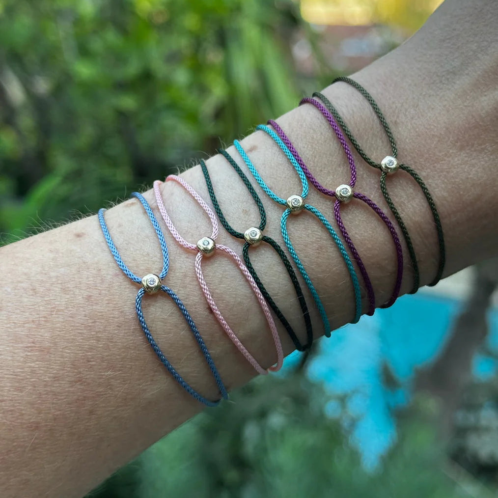 close-up of EF-Collection diamond dot cord bracelet on a model's wrist.