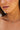 Close-up of a person wearing a delicate gold necklace with a small pendant.