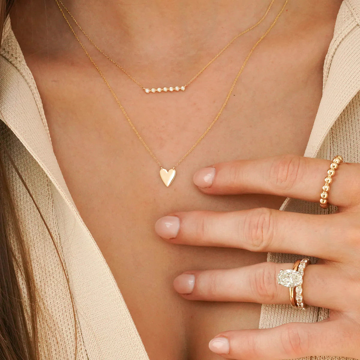 close up of Dana Rebecca Designs Lulu Jack Bezel Bar Diamond Necklace in yellow Gold layered with another necklace