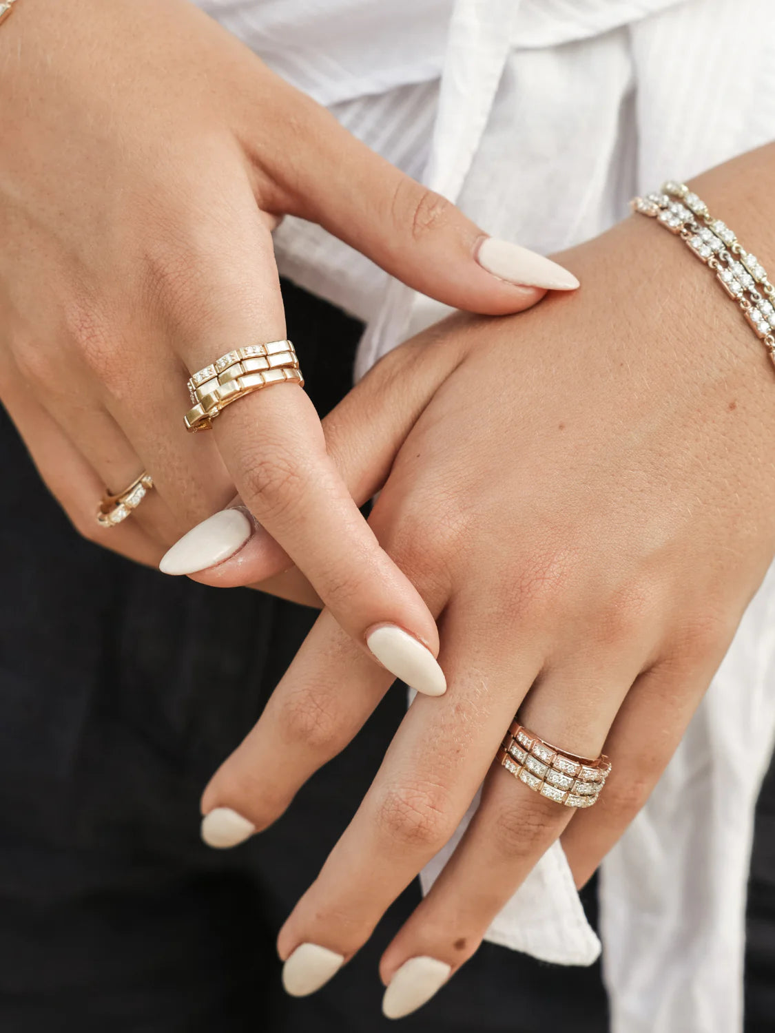 close up of Onirikka Glimmer Wave Diamond Ring in 18k yellow gold on a model's hand.