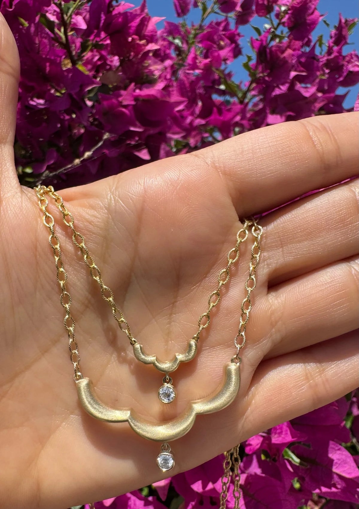 Close up of Onirikka Midi Floret Necklace in satin 14k yellow gold with a diamond pendant on an 18-inch rolo chain.