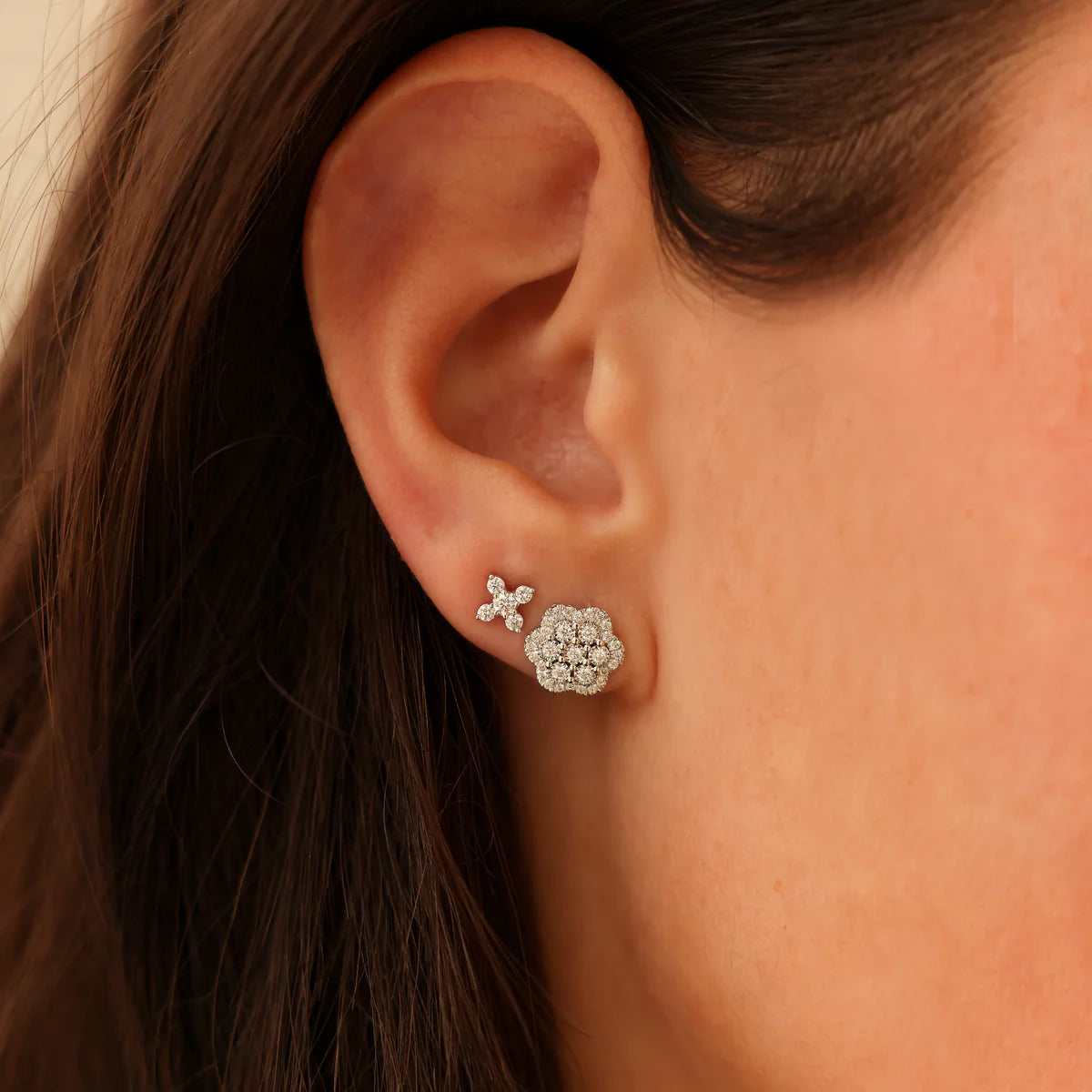 close up of Ava Bea Flower Studs in white Gold styled on an ear