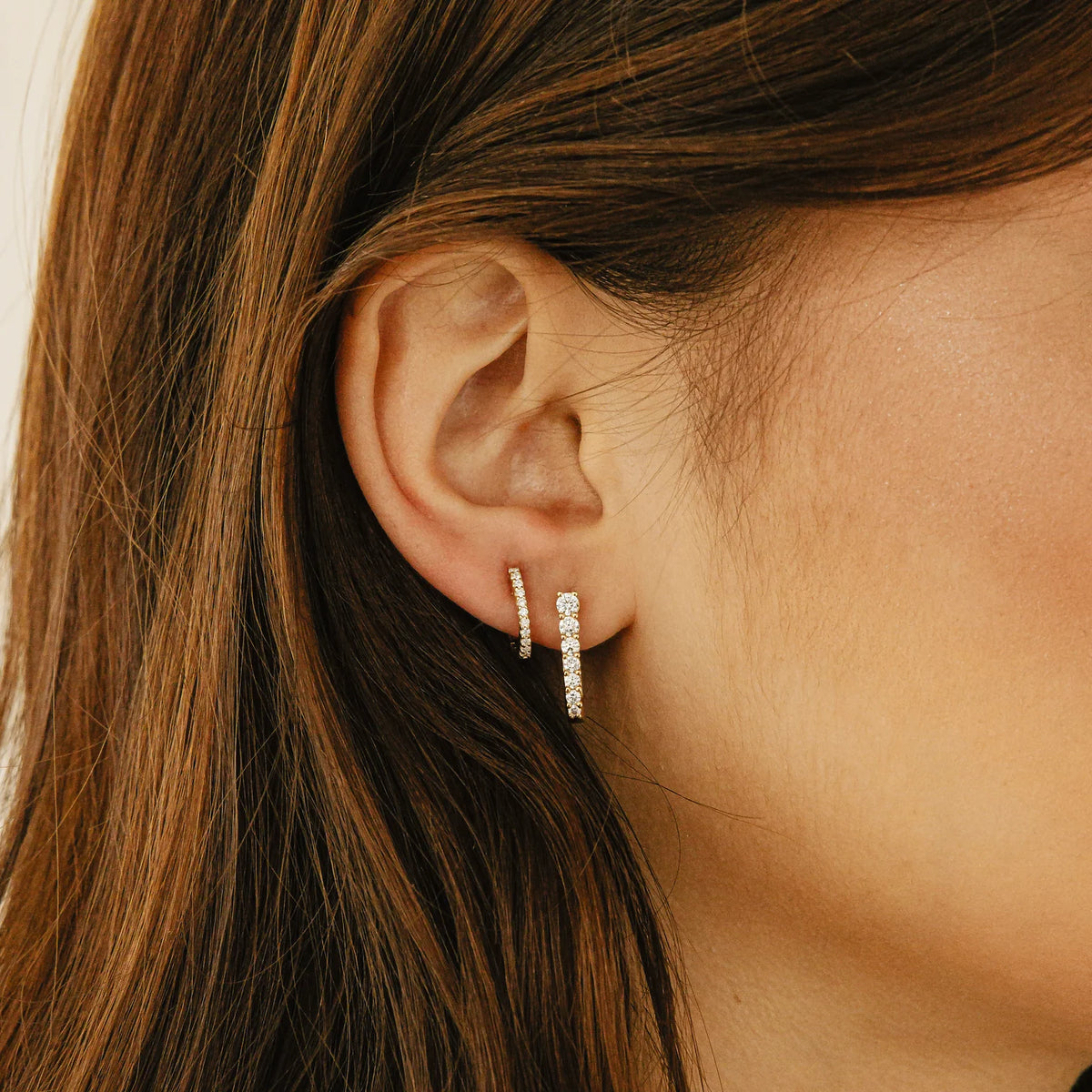 Dana Rebecca Designs Ava Bea Graduating U Hoops in yellow gold on models ear stacked with yellow gold diamond huggie 