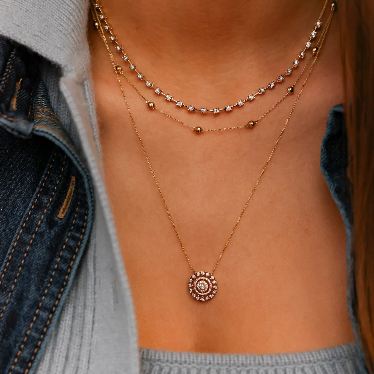Dana Rebecca Designs Ava Bea Medallion Necklace in yellow gold styled on models neck layered with ava bea tennis necklace 
