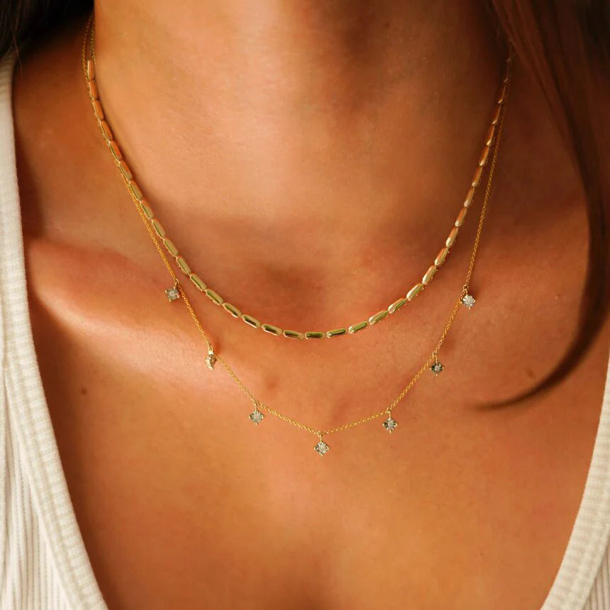 Close up of model wearing Dana Rebecca Designs Ava Bea Station Necklace in Yellow Gold