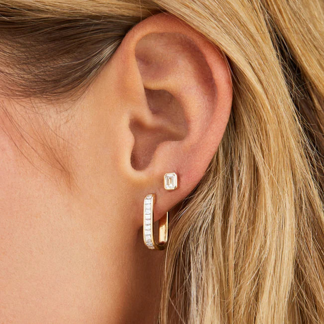 Ef collection Single Bezel Set Emerald Cut Diamond Stud Earring in yellow gold styled on models ear with a big diamond hoop. 