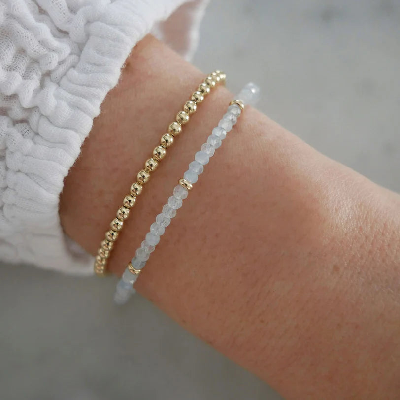 EF-Collection Birthstone Bead Bracelet In Aquamarine on models wrist with yellow gold bead bracelet 