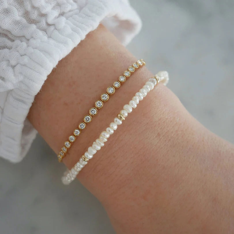 EF-Collection Birthstone Bead Bracelet In Pearl on models wrist with round diamond bracelet 