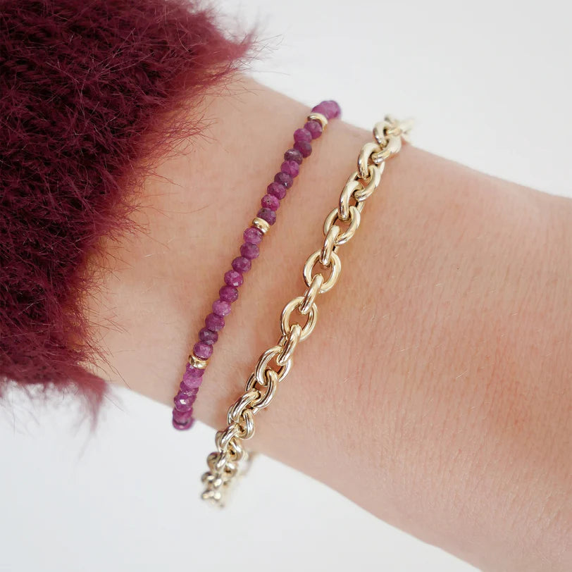 EF-Collection Birthstone Bead Bracelet In Ruby in yellow gold on models wrist with chain bracelet 