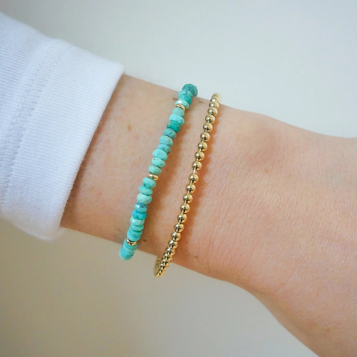 EF-Collection Birthstone Bead Bracelet In Turquoise in yellow gold on models wrist with yellow gold bead bracelet 