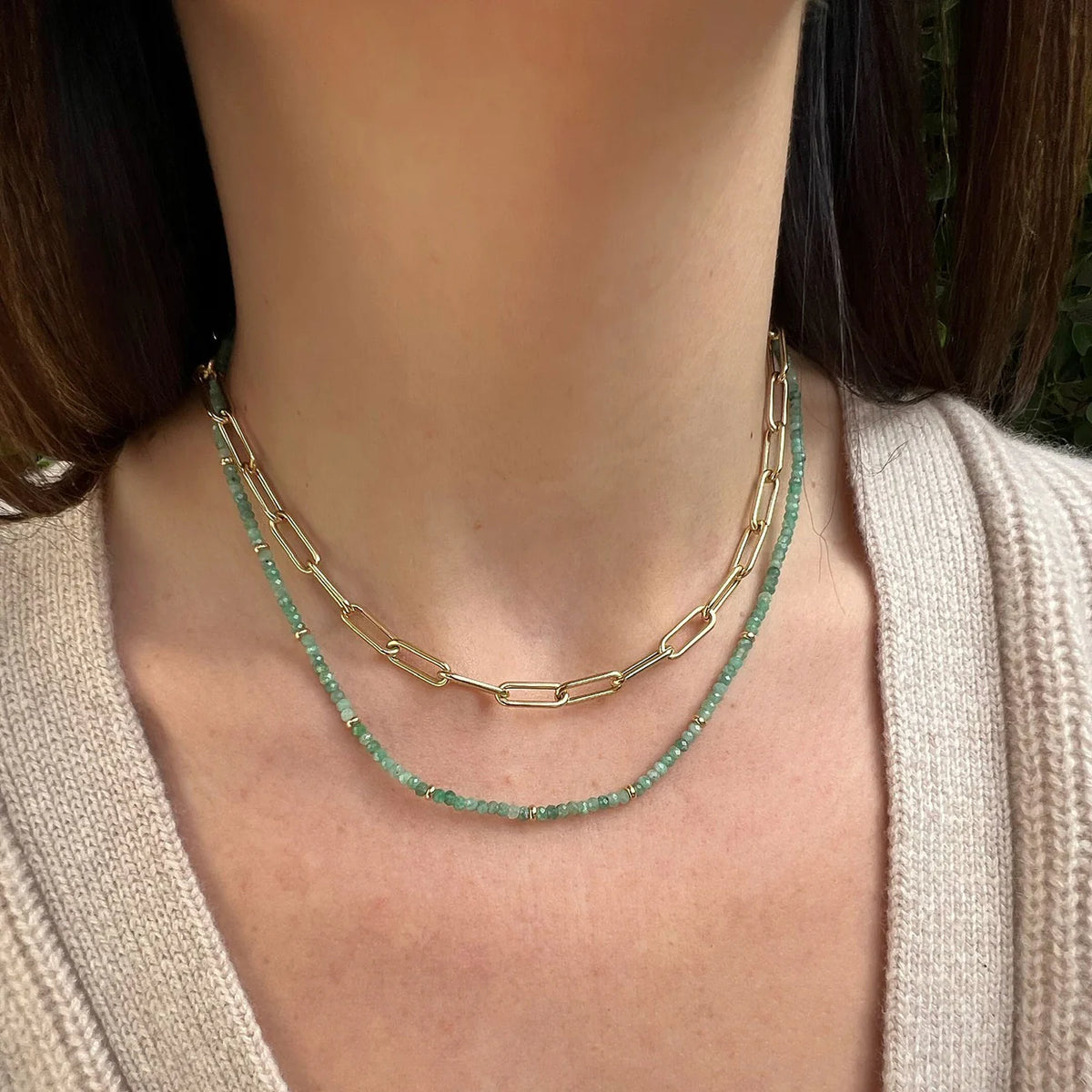 Product shot of EF-Collection Birthstone Bead Necklace In Emerald in yellow gold on models neck with jumbo chain necklace