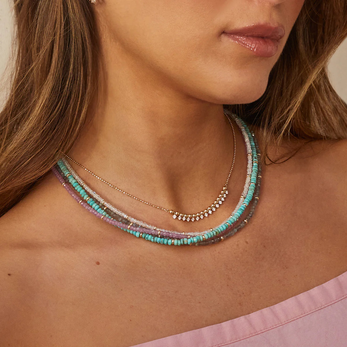 EF-Collection Birthstone Bead Necklace In Pink Sapphire in yellow gold on models neck layered with other beaded necklaces