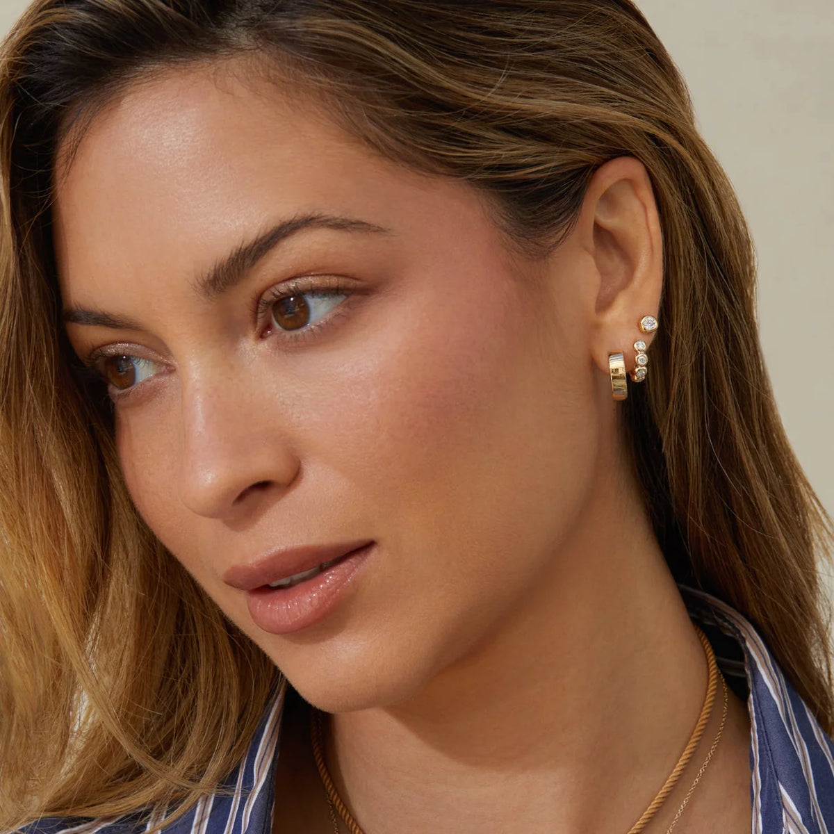 EF-Collection Charlie Hoop Earrings in yellow gold styled on models ear with diamond huggie and diamond stud 