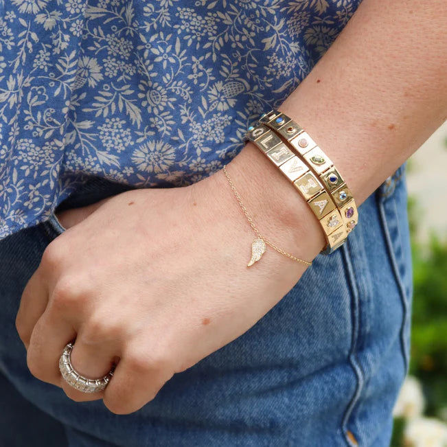 EF Collection Diamond Angel Wing Bracelet in yellow gold styled on models wrist. 