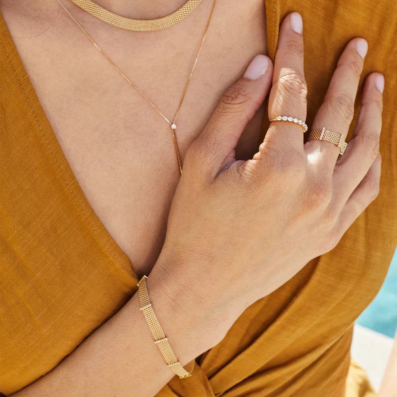 EF Collection Diamond Bar Mesh Bracelet in yellow gold styled on models wrist with mesh ring and diamond ring. 