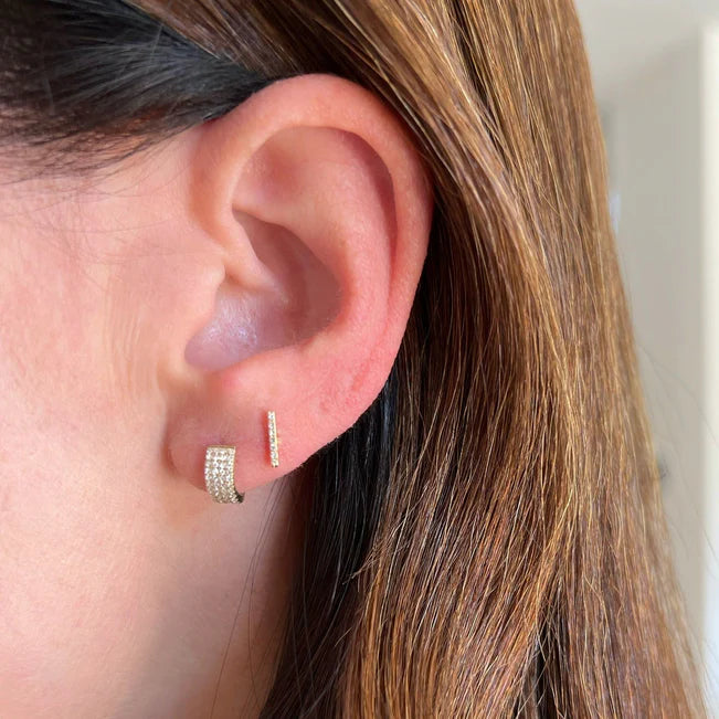 EF Collection Diamond Bar Stud Earring in yellow gold styled on models ear. 