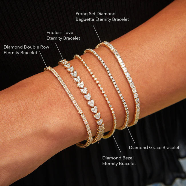 EF Collection Diamond Bezel Eternity Bracelet in yellow gold on models wrist with four eternity bracelets labeled. 