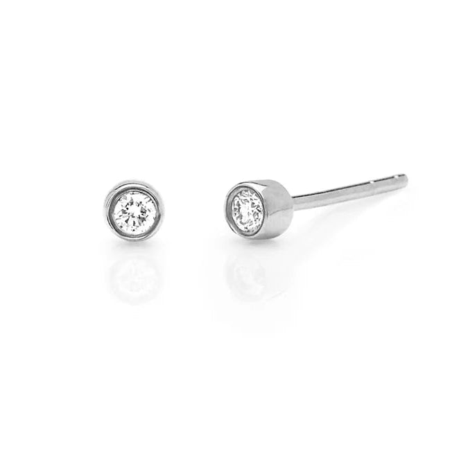Pair of silver stud earrings with clear gemstones on a white background
