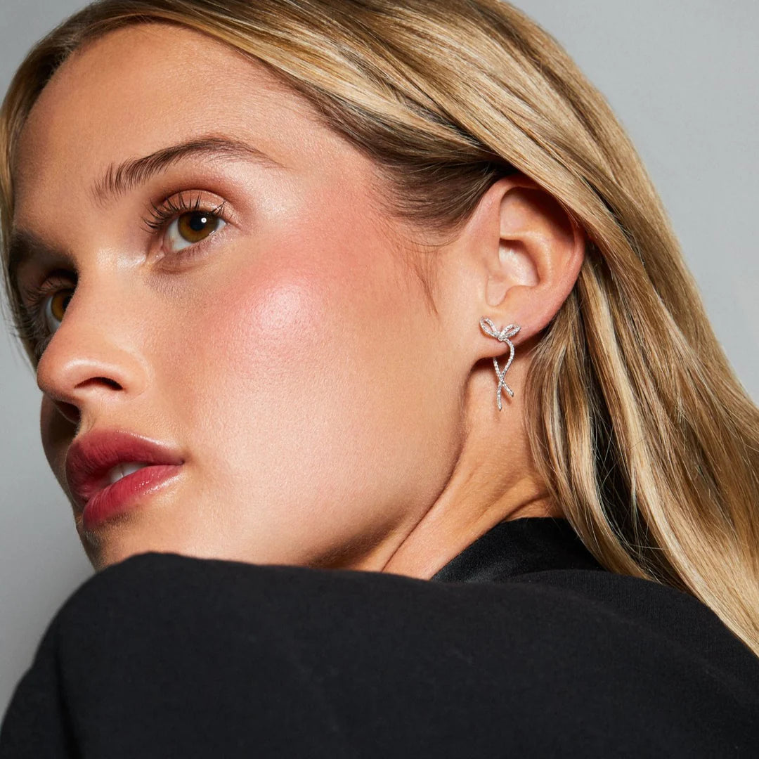 EF-Collection Diamond Bow Earrings in white gold styled on models ear 