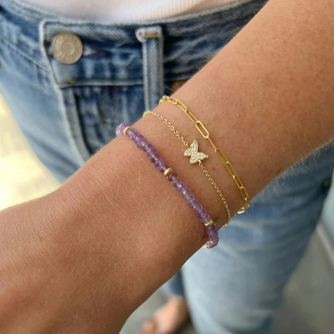 EF Collection Diamond Butterfly Bracelet in yellow gold styled on model's wrist with a chain bracelet