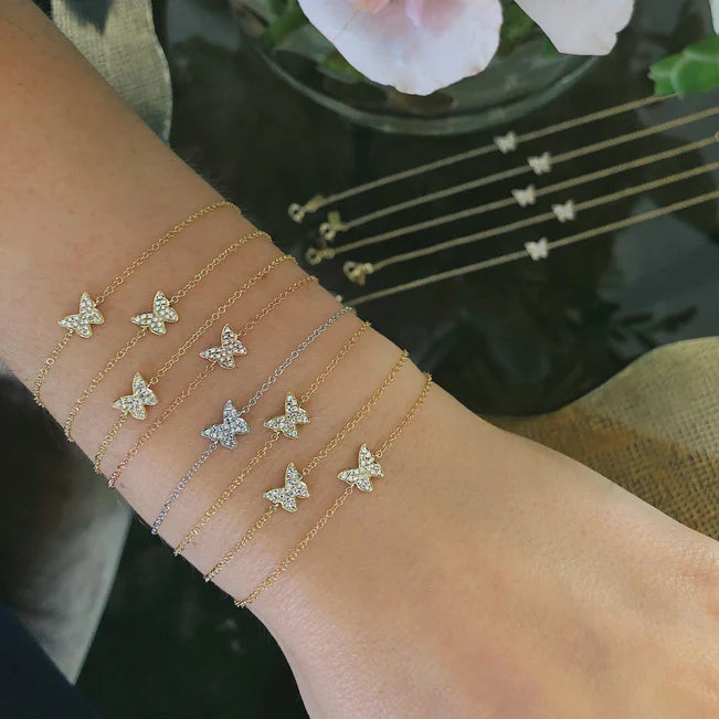 Eight EF Collection Diamond Butterfly Bracelets in yellow, white, and rose gold on models wrist. 