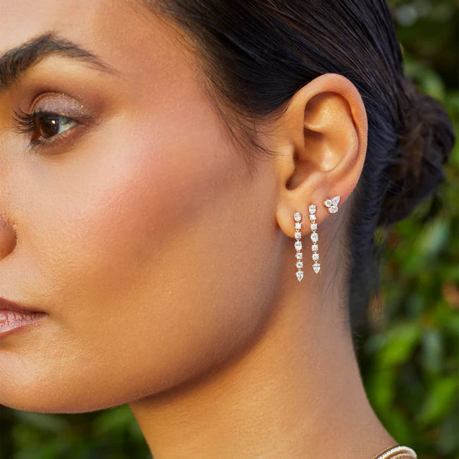 EF Collection Diamond Carrie Drop Stud Earrings in yellow gold layered in models ear. 