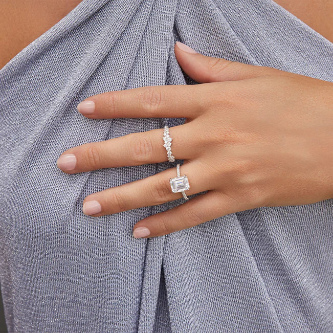 EF Collection Diamond Cluster Ring in white gold on model’s finger with engagement ring. 